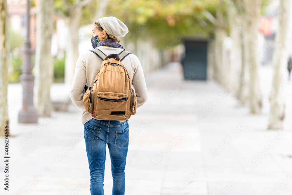 Man wearing face mask looking away while walking in city