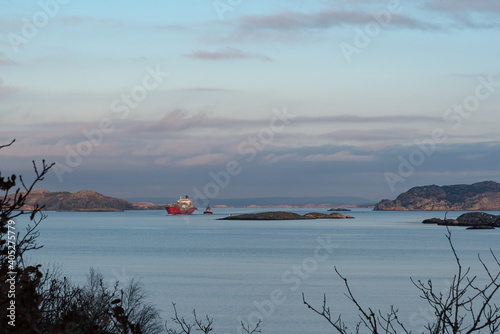 Towing of ships in perfectly calm weather with a nice sunset in progress