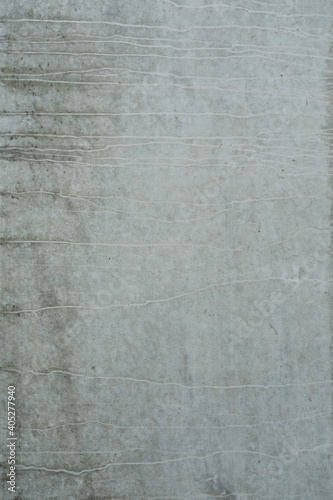 Grey cement wall with abstract surface  empty wall for a banner or background  space for text  no person and vertical format