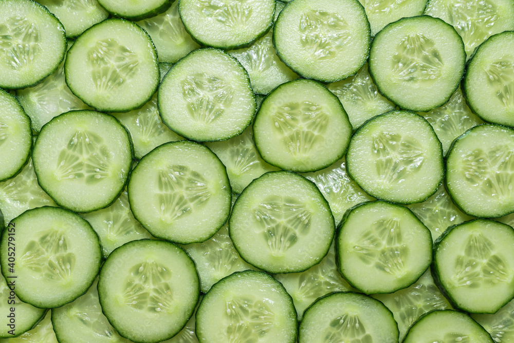 Fresh green slices of cucumber as background. Fresh green slices of cucumber as background.