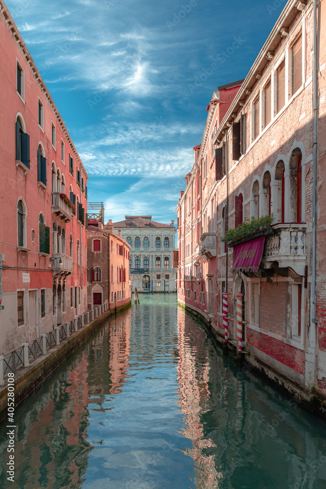 A quiet canal in Venice in sunny day with some clouds