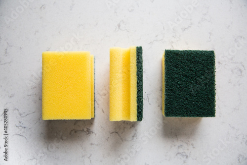 Kitchen sponges on a marble kitchen counter, top view. photo