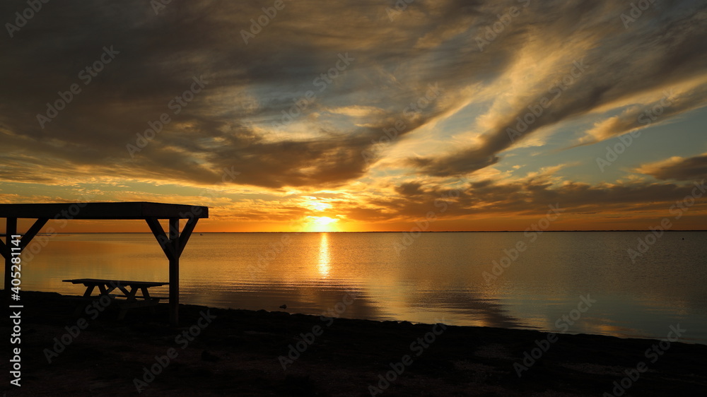 Silhouetted picnic table on the beach during a gorgeous sunset from Padre Island, Texas; clouds and sun reflected in water; copy space
Silhouetted picnic table on the beach during a gorgeous sunset from Padre Island, Texas; clouds and sun reflected in water; copy space