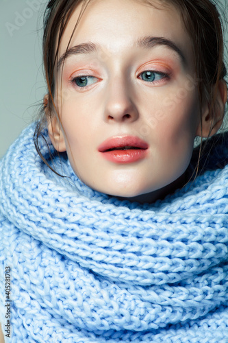 beauty young blond woman in scarf with weathered lips close up, dehydrated winter skin cosmetic concept