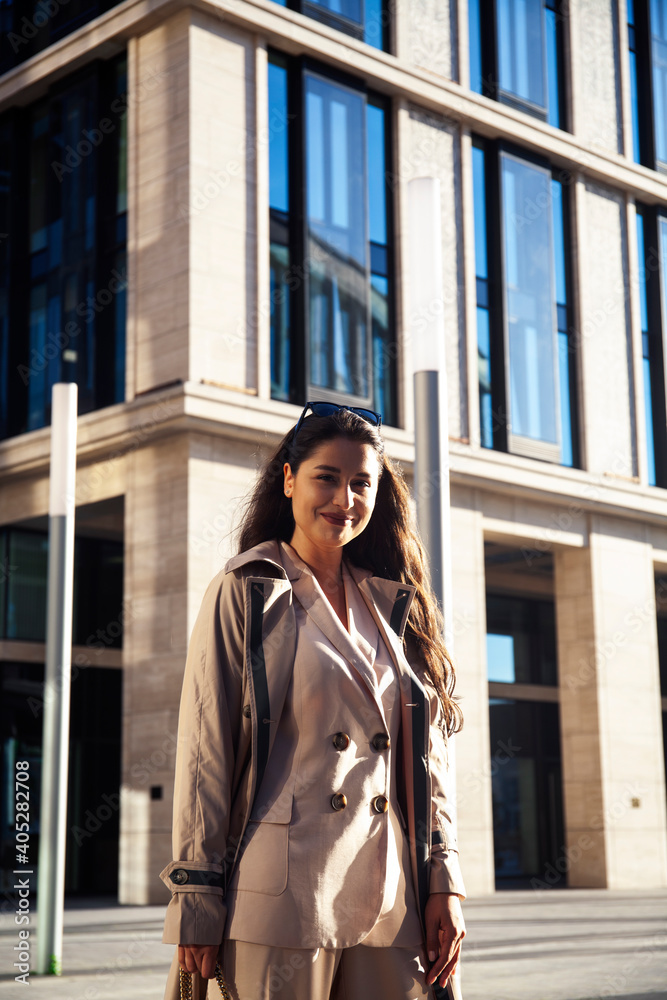 young pretty brunette woman in fashion suit at business building posing cheerful, lifestyle people concept young pretty brunette woman in fashion suit at business building posing cheerful, lifestyle people concept