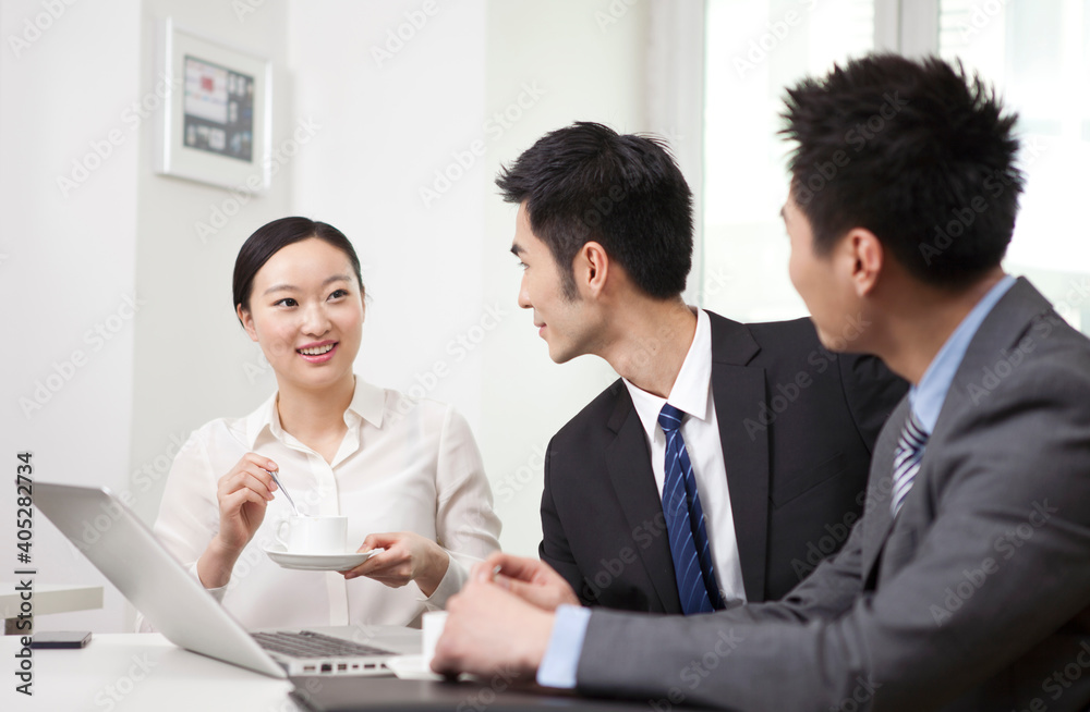 Group of business people chatting in office Group of business people chatting in office