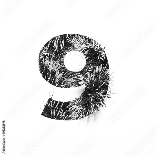 Black number nine made of tinsel and paper cut shape of ninth numeral isolated on white. Monochrome stylish digits