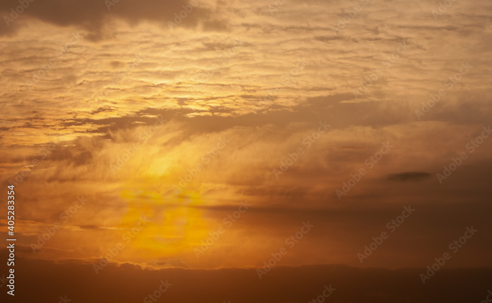 Dramatic winter sunrise with cloudy orange sky in winter