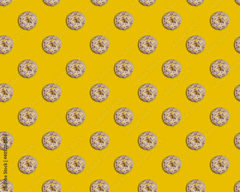 White doughnuts on yellow background seamless pattern White doughnuts on yellow background seamless pattern