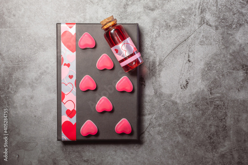 Red love potion with pink heart shaped sweets
