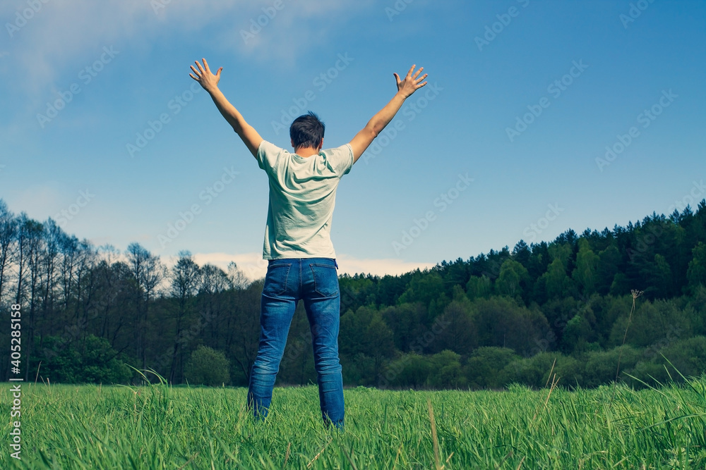 Guy in nature with his hands up. Happiness and freedom. Guy in nature with his hands up. Happiness and freedom.