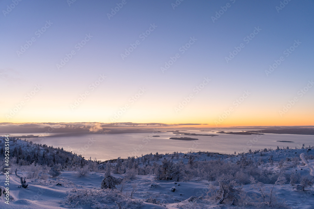 Cloudy sunrise in mountain forest with lake