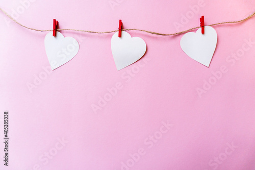 white paper hearts hanging on the clothesline. Greeting card with copy space for your text or advertising