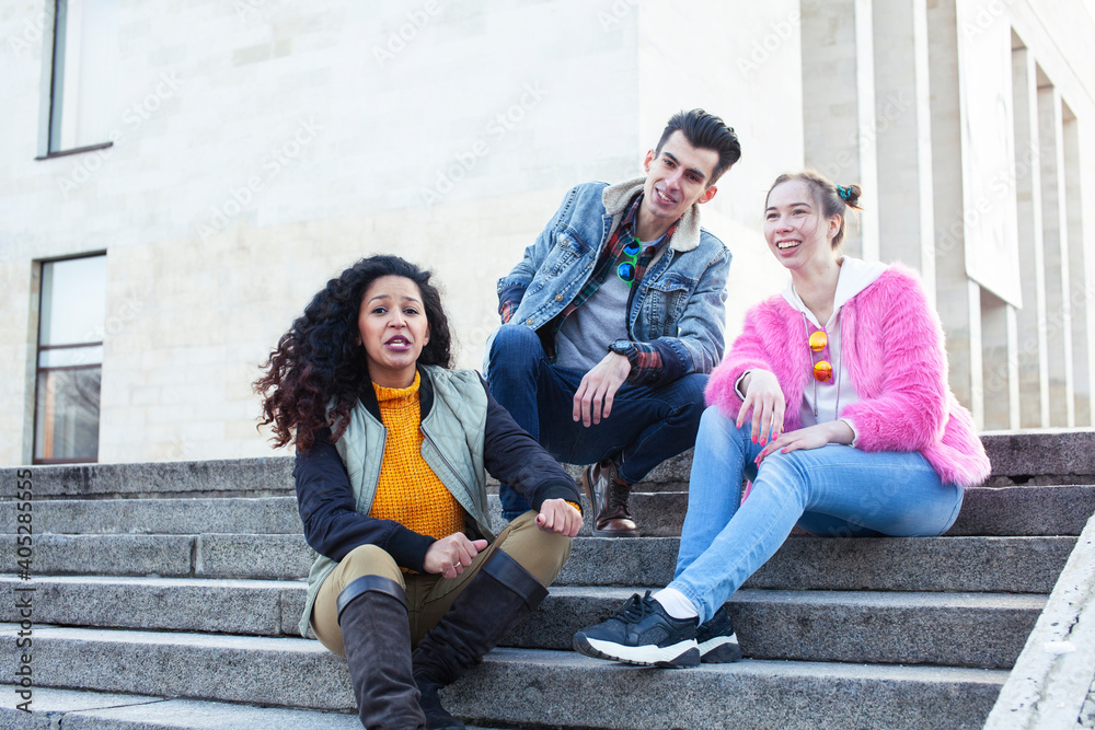 Fototapeta premium cute group of teenages at the building of university with books huggings, diversity nations real students lifestyle