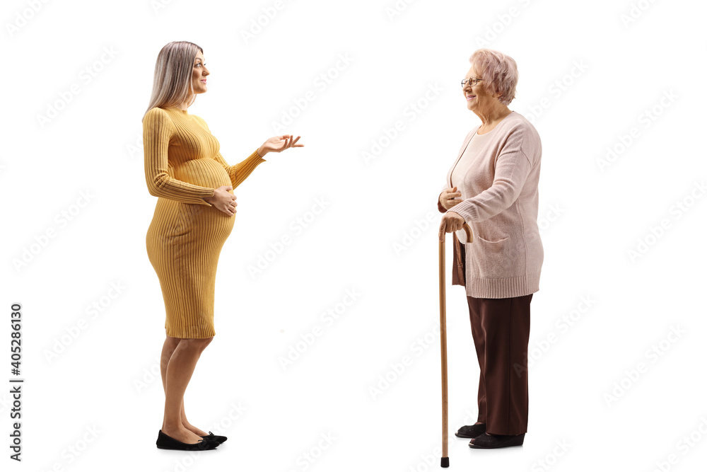 Full length profile shot of a pregnant woman talking to an elderly woman Full length profile shot of a pregnant woman talking to an elderly woman