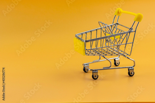shopping carts isolated on yellow background. Sales and promotions. Grocery store and supermarket. Go shopping.