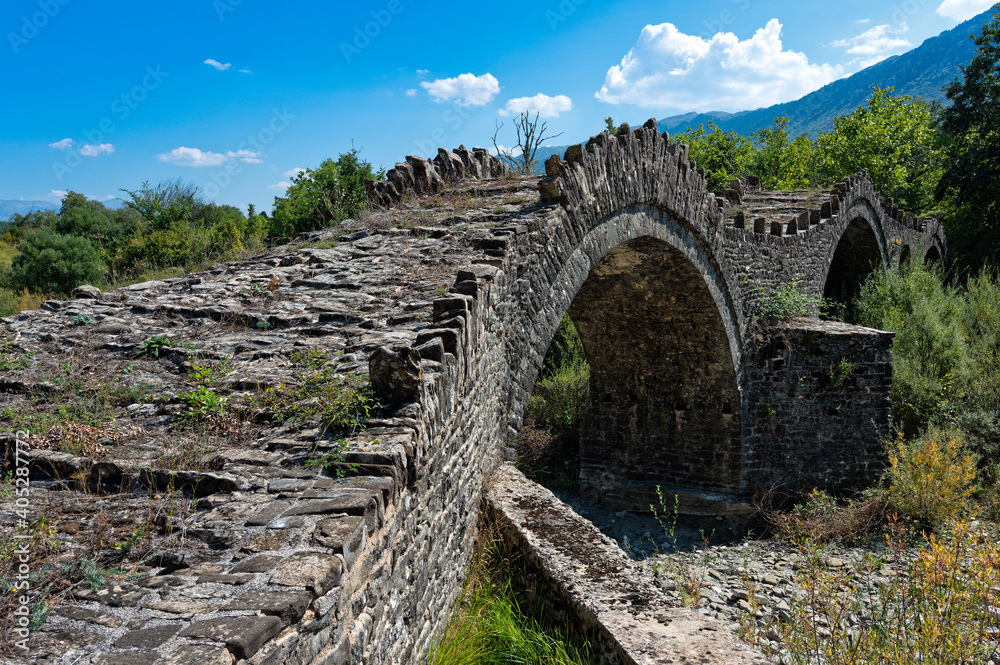 View of the traditional stone Kalouta Bridge in Epirus, Greece.