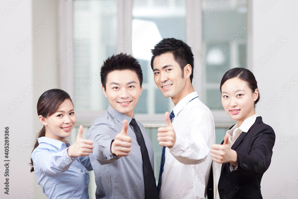 Group of young business people giving the Thumbs-up Sign Group of young business people giving the Thumbs-up Sign
