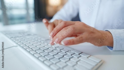 Female hands typing on a computer keyboard. Concept of remote work. photo