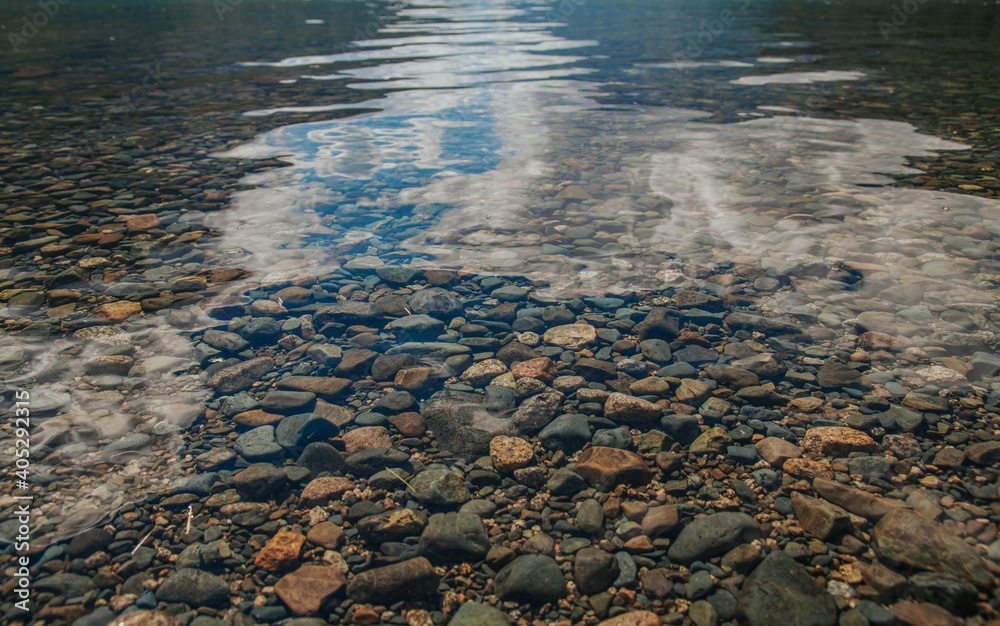 Pebbles and rocks underwater in the lake. Rocky bottom.