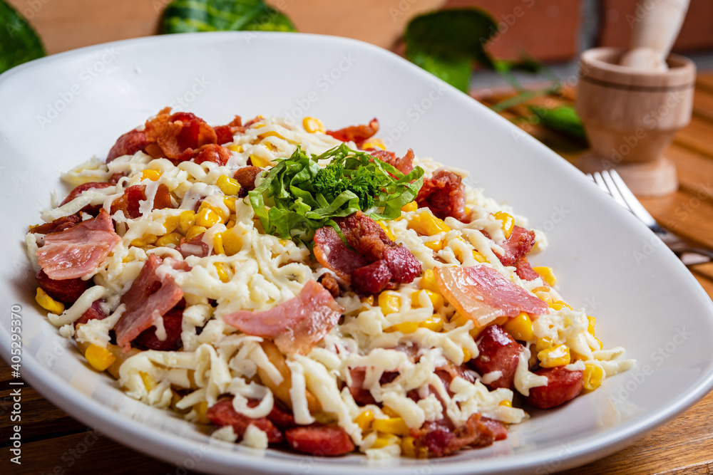 plate of food with corn bacon, cheese and vegetables
plate of food with corn bacon, cheese and vegetables