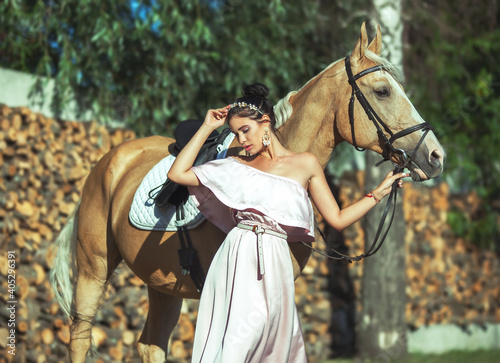 Beautyful woman in dress with horse