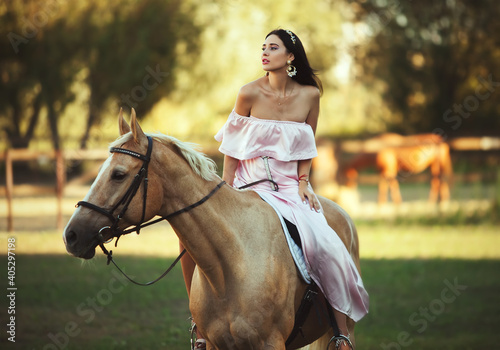 Beautyful woman in dress with horse