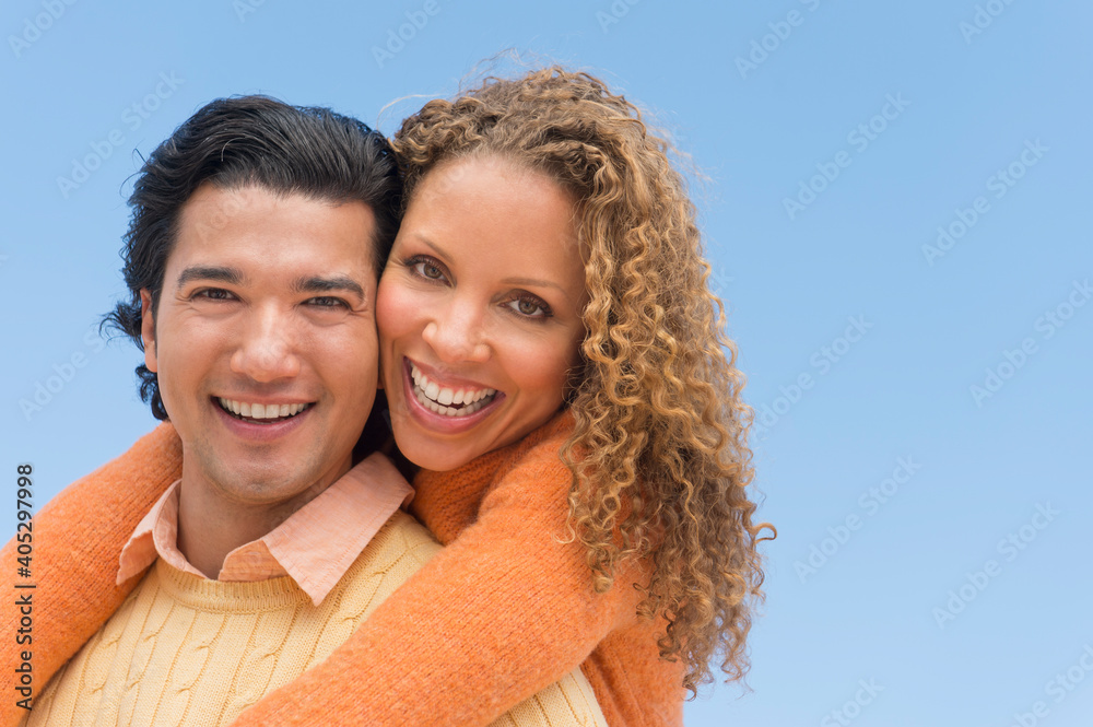 Portrait of couple against blue sky