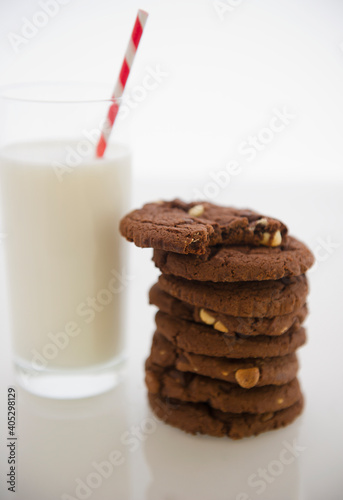 Close up of glass of milk and chocolate cookies photo