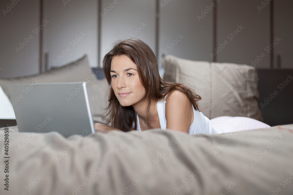 Woman in bed using laptop Woman in bed using laptop