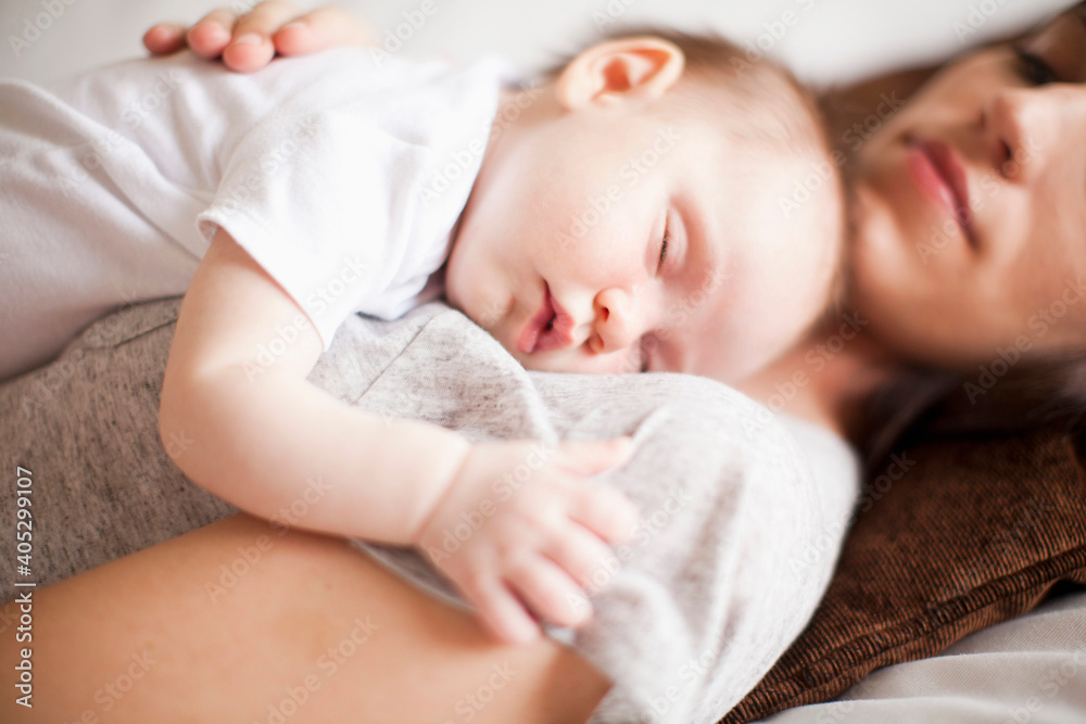 Mother and baby girl (2-5 months) sleeping together Mother and baby girl (2-5 months) sleeping together