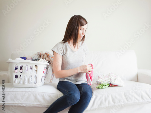 Young woman doing laundry photo