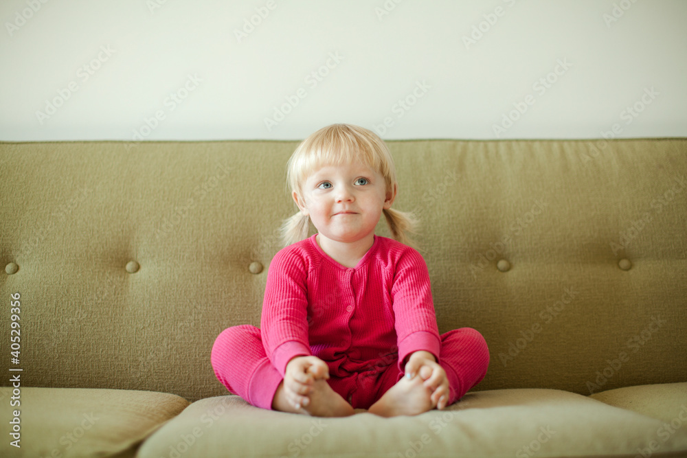 Portrait of baby girl (18-23 months) sitting on sofa Portrait of baby girl (18-23 months) sitting on sofa