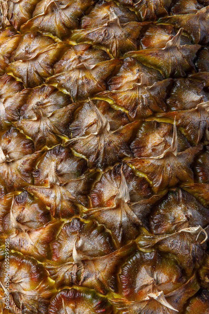 A fragment of a ripe juicy pineapple. Texture of the fruit skin close-up. A fragment of a ripe juicy pineapple. Texture of the fruit skin close-up.