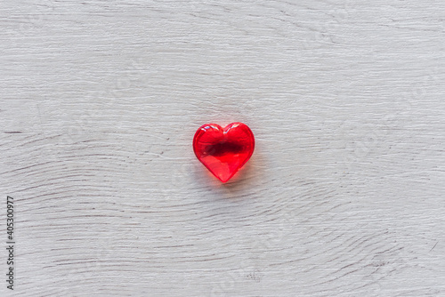 Red heart on wooden table