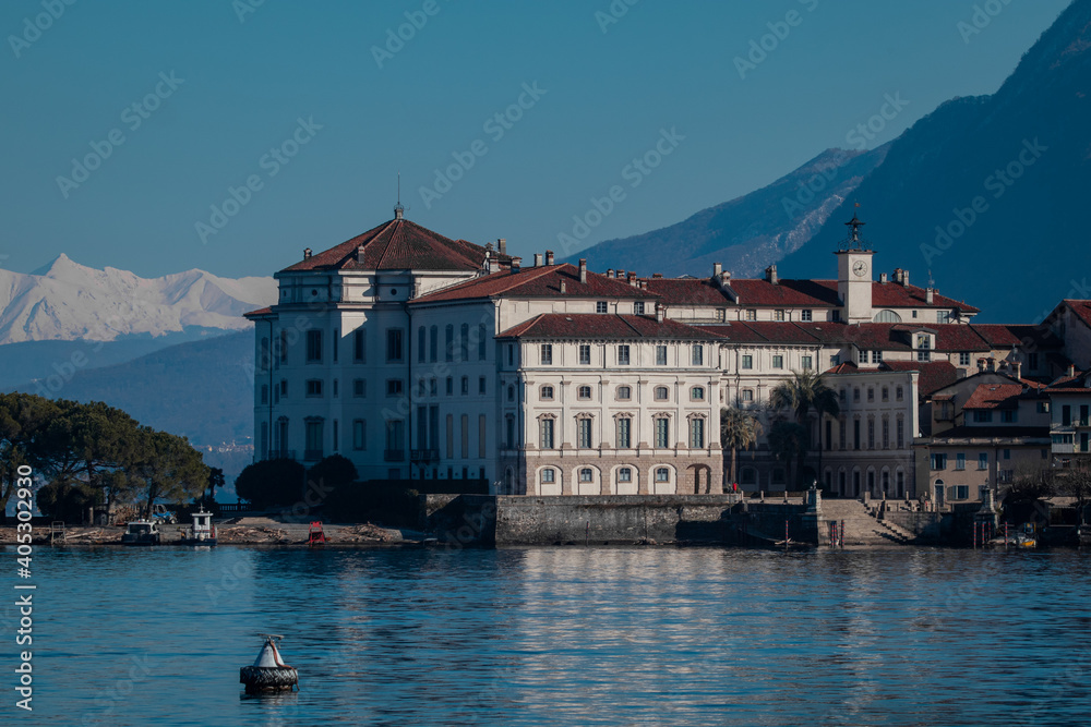 Isola Bella on Lake Maggiore, italy with view of the island and Palazzo Borromeo on a cold winter day. Snowy mountains in the background.