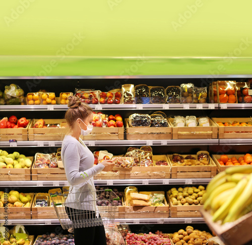 Supermarket shopping, face mask and gloves,woman buying vegetables at the market.