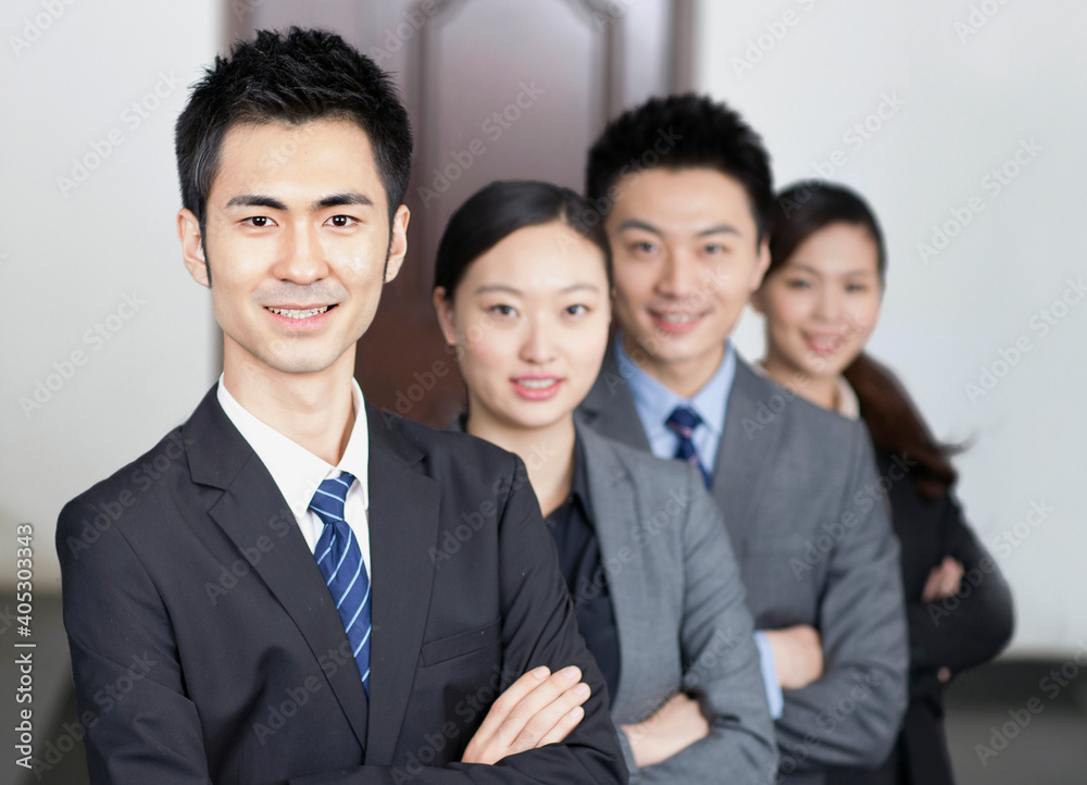 Four young office workers with hands crossed indoors,portrait Four young office workers with hands crossed indoors,portrait