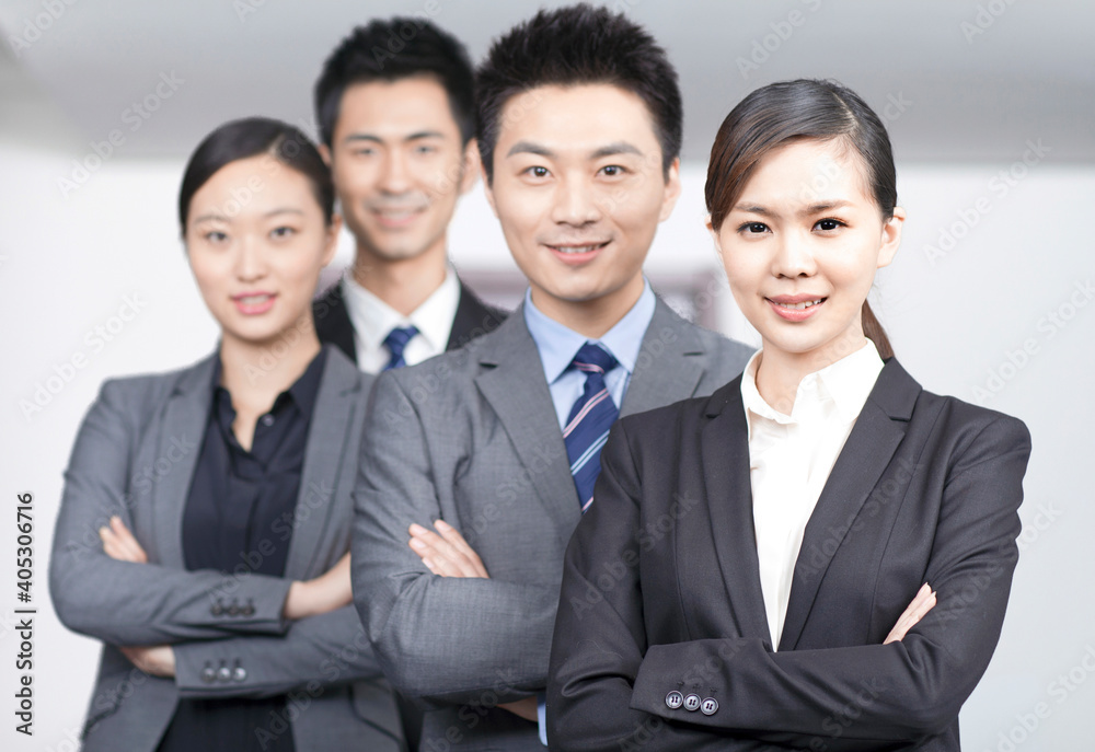Four young office workers with hands crossed indoors,portrait Four young office workers with hands crossed indoors,portrait