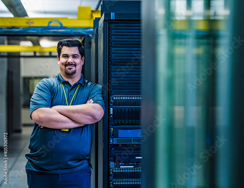 Smiling employee standing in data center