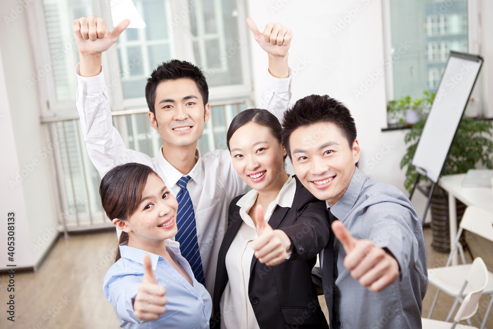 Group of young business people giving the Thumbs-up Sign