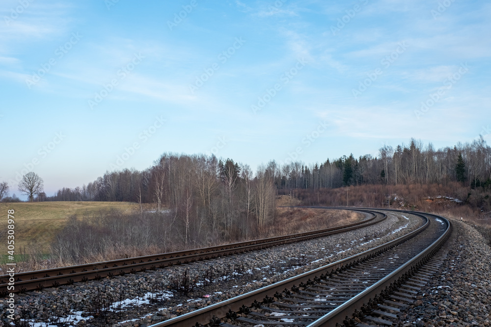 railway tracks that form a bend with a scenic view of the swamps of Latvia