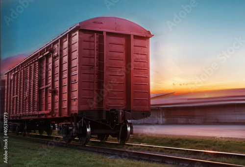 Freight train traveling by rail. View of the rear carriage of the train.