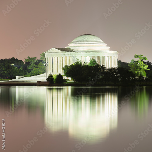 USA, Washington DC, Jefferson Memorial reflecting in Tidal Basin at dusk photo