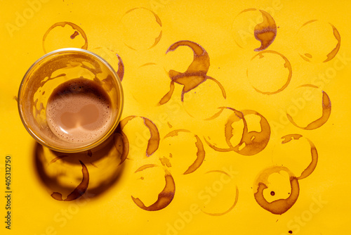 Coffee cup on coffee stained yellow table