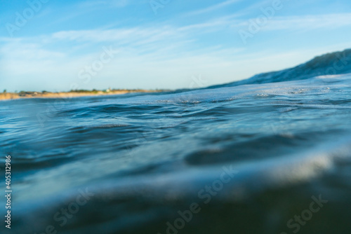 Breaking Waves and spray, white water and light reflected on the surface of the water