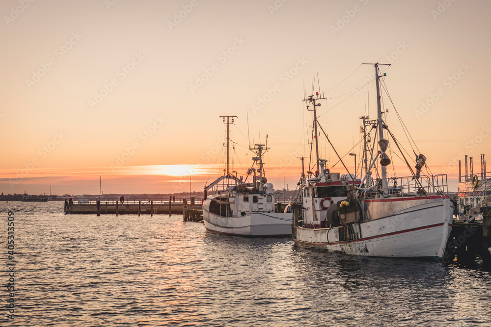 Germany, Schleswig-Holstein, Heikendorf, Fishing boats moored in harbor at sunset Germany, Schleswig-Holstein, Heikendorf, Fishing boats moored in harbor at sunset