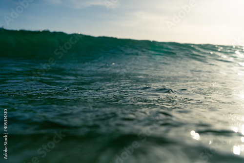 Breaking Waves and spray, white water and light reflected on the surface of the water