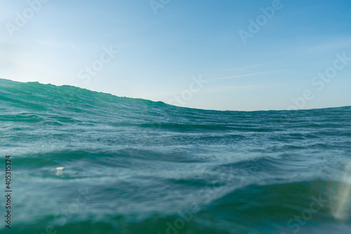 Breaking Waves and spray, white water and light reflected on the surface of the water