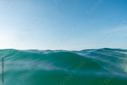 Breaking Waves and spray  white water and light reflected on the surface of the water